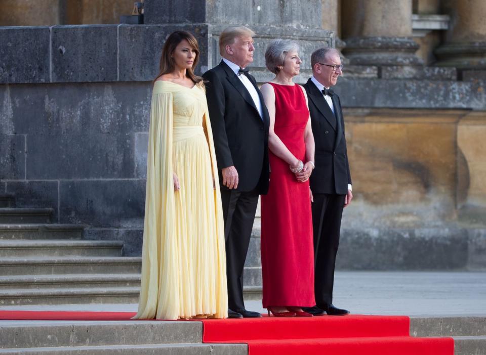 For a dinner with Theresa May at Blenhiem Palace, Melania turned heads in a stunning lemon yellow J.Mendel gown costing £5000. [Photo: Rex]