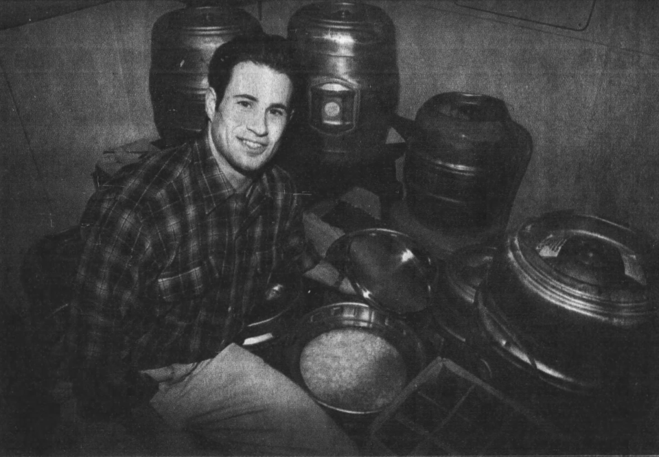 Sam Calagione takes the lid off a keg of Boothbay Barleywine beer that's almost finished fermenting, as seen in a Feb. 28, 1996, clipping from The Daily Times.