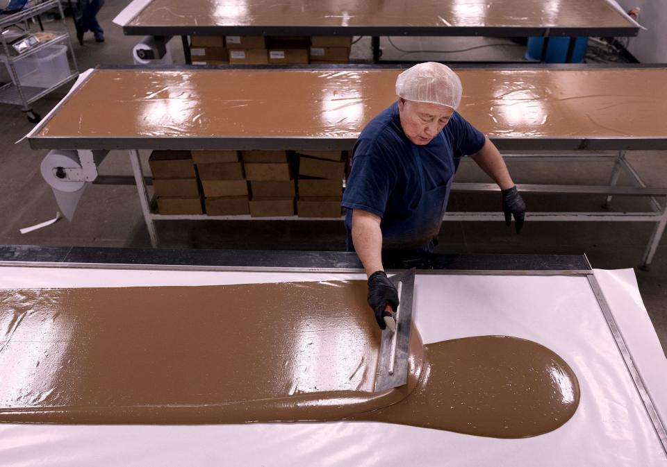 Walter Garcia spreads milk chocolate at Fernwood Candy Company in Logan on Thursday, Nov. 30, 2023. | Laura Seitz, Deseret News