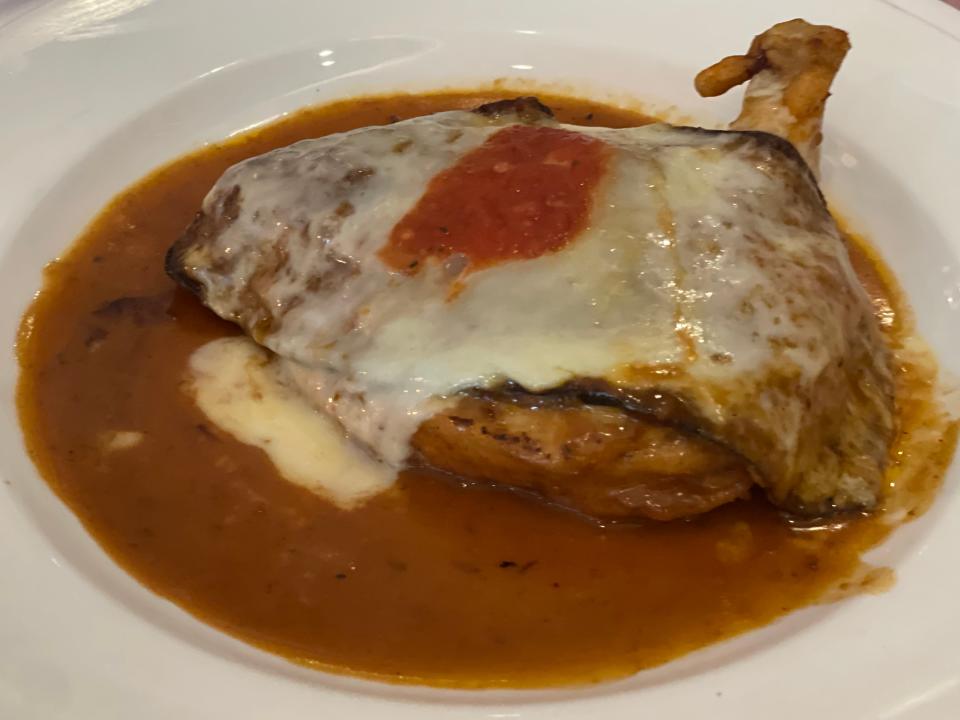 chicken dish with cheese and eggplant on a plate with sauce