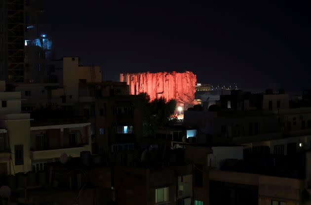 Lebanon marks one year anniversary of Beirut port explosion by lighting up a damaged building. (Photo: EMILIE MADI via REUTERS)