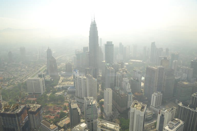 Kuala Lumpur's skyline is seen covered by haze, on June 27, 2013. Five Southeast Asian nations meet later on Monday to discuss the hazardous smog that blights the region every year but the affected countries hold little hope of a permanent solution