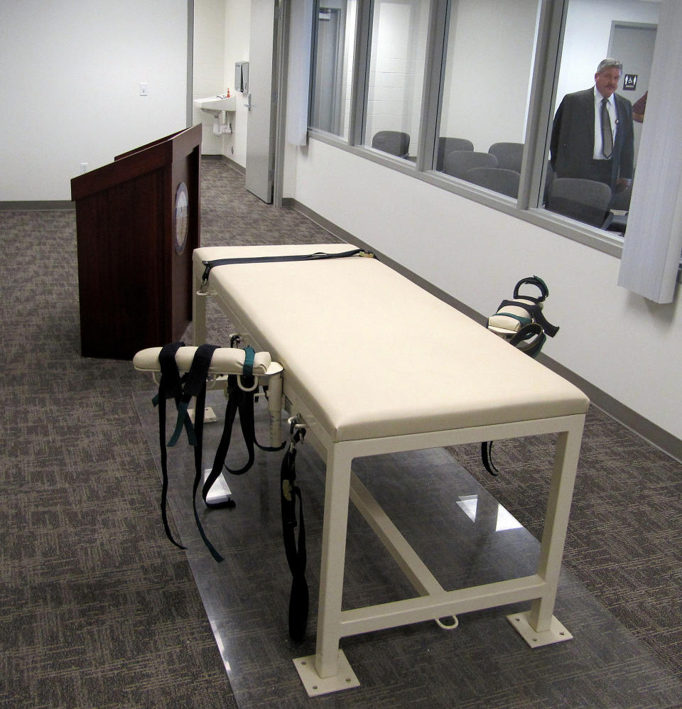 FILE - The execution chamber at the Idaho Maximum Security Institution is shown as Security Institution Warden Randy Blades look on in Boise, Idaho on Oct. 20, 2011. A bill that would allow Idaho to kill condemned inmates by firing squad is headed to the governor's desk after passing the Legislature with a veto-proof majority. Firing squads will only be used if the state cannot obtain the drugs needed for lethal injections. (AP Photo/Jessie L. Bonner, File)