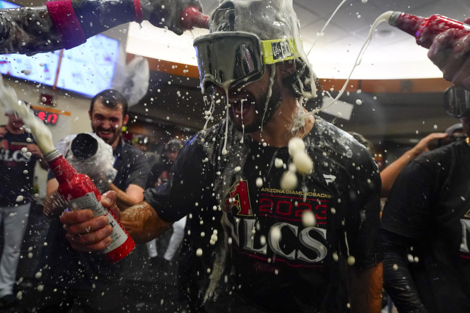 Arizona Diamondbacks starting pitcher Zac Gallen celebrates with teammates after the Diamondbacks defeated the Los Angeles Dodgers 4-2 in Game 3 to win a baseball NL Division Series, Wednesday, Oct. 11, 2023, in Phoenix. (AP Photo/Ross D. Franklin)