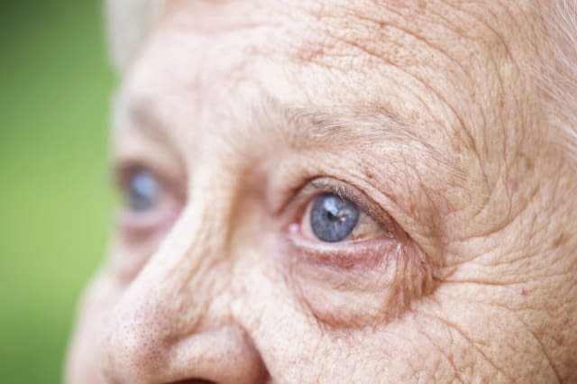 Close up of older woman's blue eye