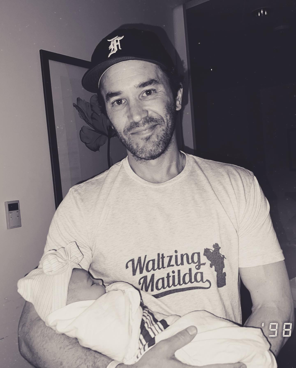 Tom Pelphrey holding his daughter Matilda while wearing a ‘Waltzing Matilda’ t-shirt.