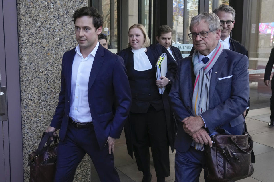 Australian journalists Nick McKenzie, left, and Chris Masters, right, walk with their legal team from the Federal Court in Sydney, Australia, Thursday, June 1, 2023. Australia’s most decorated living war veteran unlawfully killed prisoners and committed other war crimes in Afghanistan, a judge ruled Thursday in dismissing the claims by Victoria Cross recipient Ben Roberts-Smith that he was defamed by media. (AP Photo/Mark Baker)