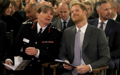  Prince Harry sits next to London Fire Brigade Commissioner Dany Cotton at the London Fire Brigade carol service at Westminster Cathedral - Credit: Peter Nicholls /Getty