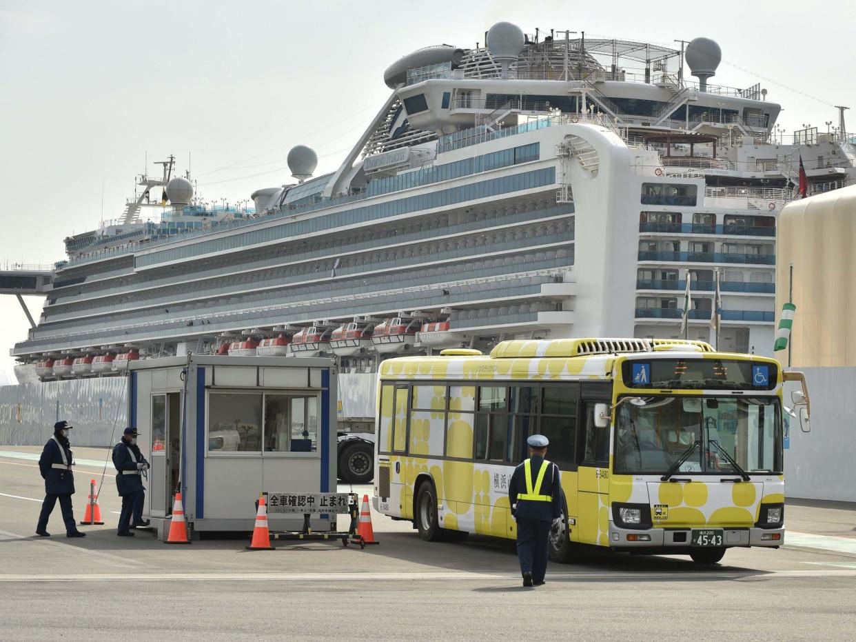 A bus carrying passengers who disembarked from the Diamond Princess cruise ship, which is in quarantine in Yokohama, Japan, following an outbreak of the new COVID-19 coronavirus, 20 February, 2020: Kazuhiro Nogi/AFP via Getty Images