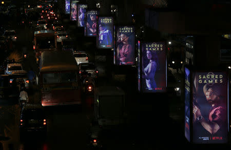 FILE PHOTO: Traffic moves on a road past hoardings of Netflix's new television series "Sacred Games" in Mumbai, India, July 11, 2018. REUTERS/Francis Mascarenhas