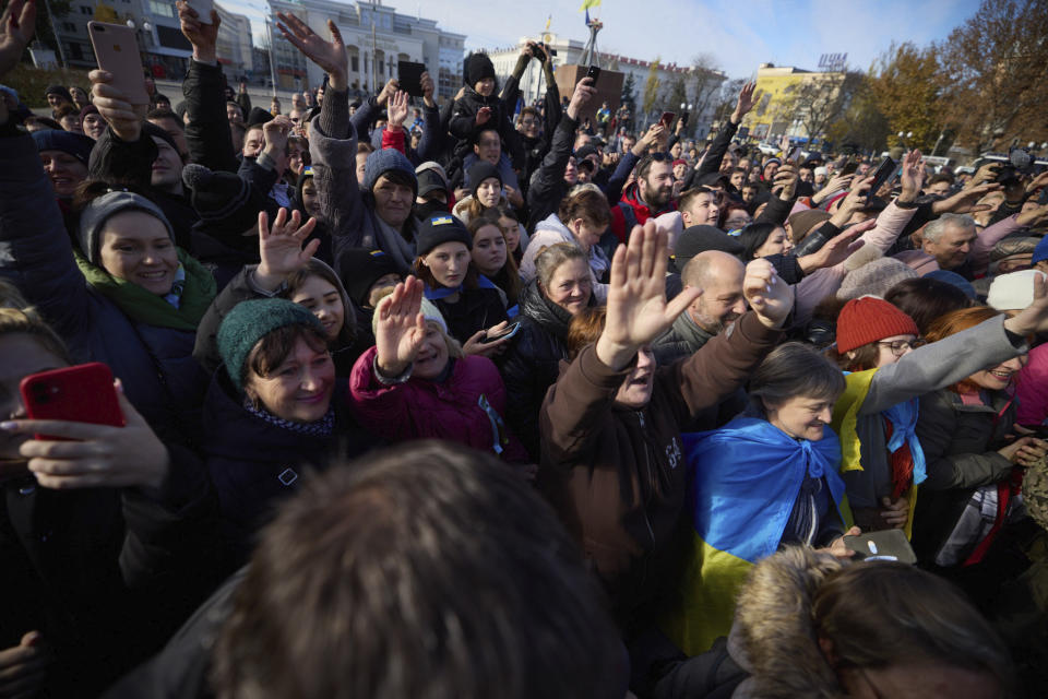 In this photo provided by the Ukrainian Presidential Press Office and posted on Facebook, local residents greet Ukrainian President Volodymyr Zelenskyy during his visit to Kherson, Ukraine, Monday, Nov. 14, 2022. Ukraine's retaking of Kherson was a significant setback for the Kremlin and it came some six weeks after Russian President Vladimir Putin annexed the Kherson region and three other provinces in southern and eastern Ukraine — in breach of international law — and declared them Russian territory. (Ukrainian Presidential Press Office via AP)
