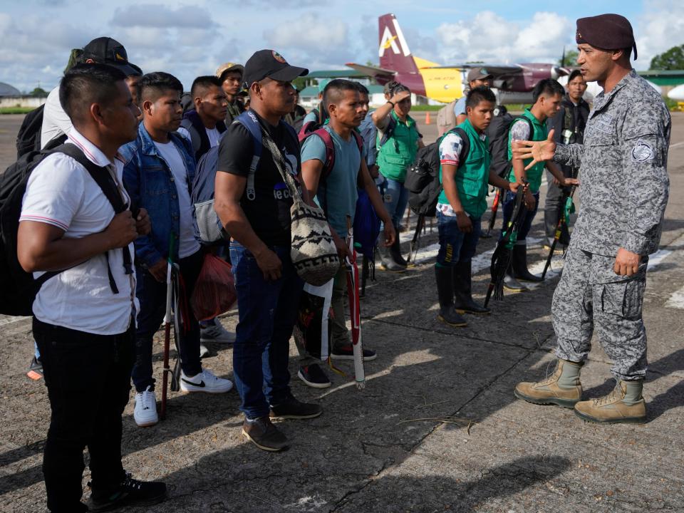 General Pedro Sanchez, the commander of the joint command of special operations of the military forces, welcomes Indigenous people the airport in San Jose del Guaviare, Colombia, Sunday, May 21, 2023, after they arrived to help in the search of four Indigenous children who are missing after a deadly plane crash. The May 30 discovery of footprints of a small foot rekindled the hope of finding the children alive after their plane crashed on May 1. Soldiers found the wreckage and the bodies of three adults, including the pilot and the children's mother.