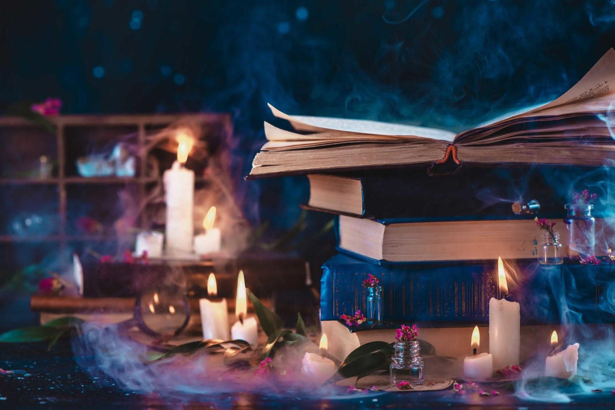 Stack of vintage books in fantasy scene with candles. Magical studies and reading in candlelight concept. Dark still life with copy space. (Dina Belenko Photography / Getty Images)