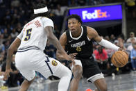 Memphis Grizzlies forward GG Jackson (45) handles the ball against Denver Nuggets guard Kentavious Caldwell-Pope (5) in the first half of an NBA basketball game Sunday, April 14, 2024, in Memphis, Tenn. (AP Photo/Brandon Dill)