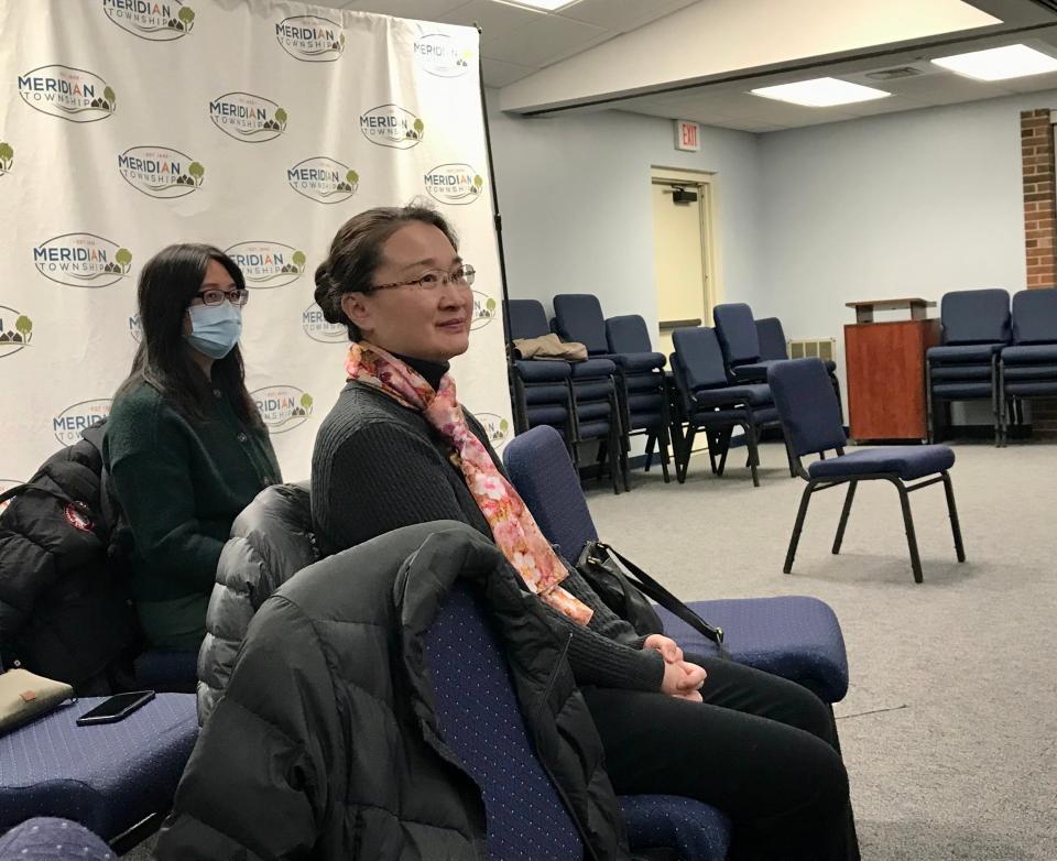 Greater Lansing Chinese Association Vice President Jane Li and treasurer Yin Zhang listen as former president Yi Shi presents to the Meridian Economic Development Corp. Jan. 5, 2023.