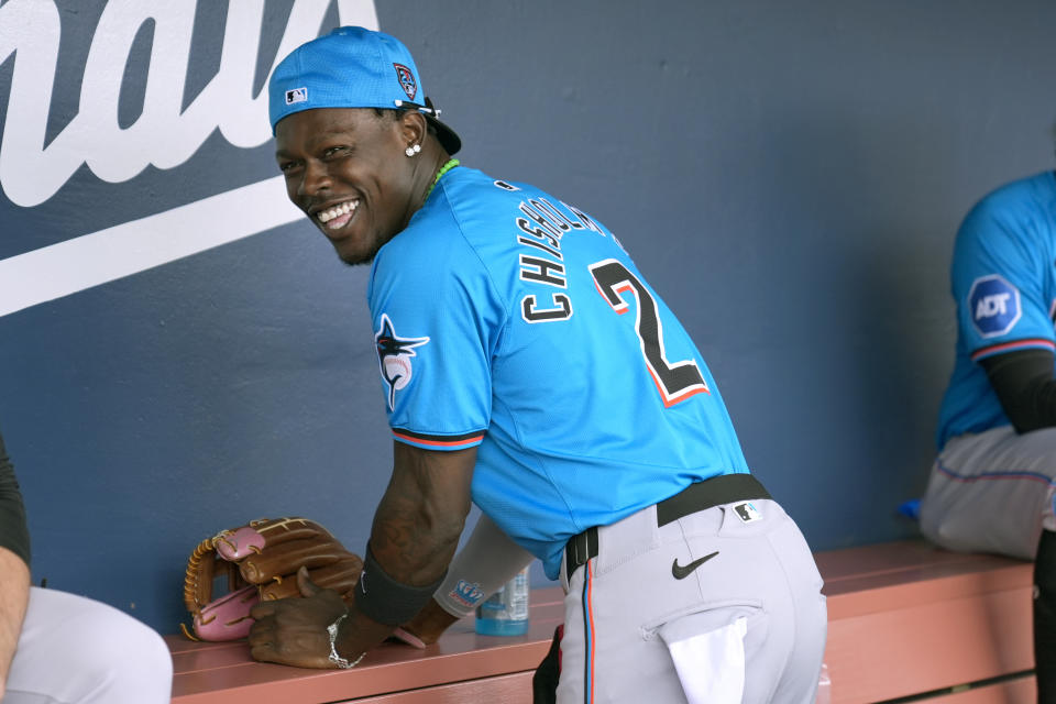 Miami Marlins' Jazz Chisholm Jr. laughs with teammates in the dugout before the start of a spring training baseball game against the Houston Astros Sunday, March 10, 2024, in West Palm Beach, Fla. (AP Photo/Jeff Roberson)