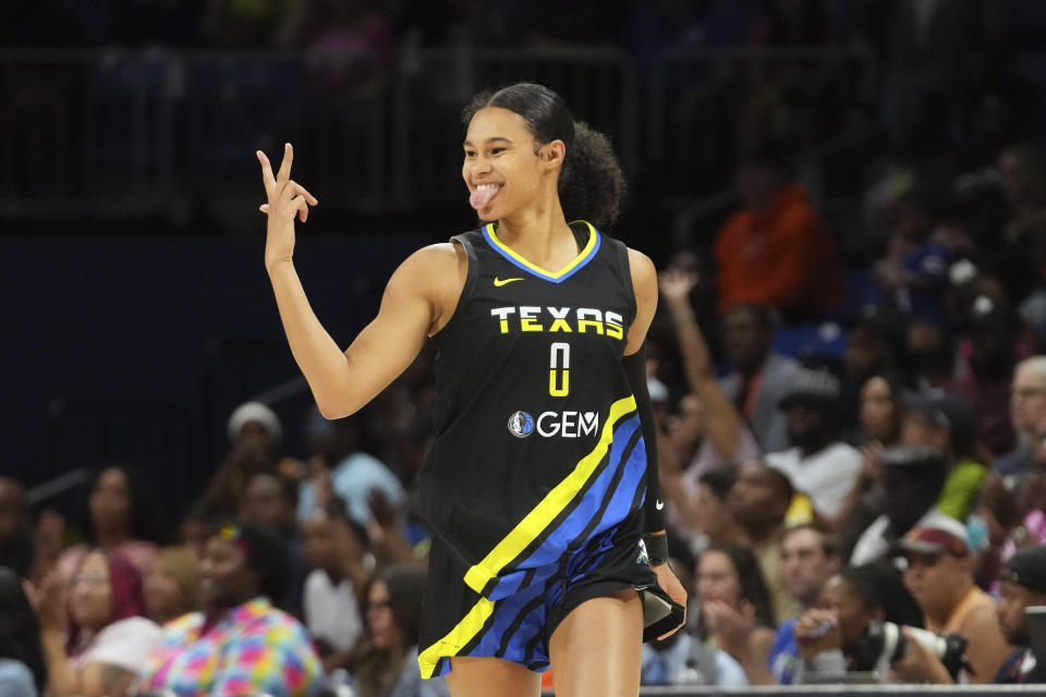 Dallas Wings forward Satou Sabally reacts to scoring a 3-point basket during the second half of a WNBA basketball basketball game against the Connecticut Sun in Arlington, Texas, Saturday, Aug. 12, 2023. (AP Photo/LM Otero)