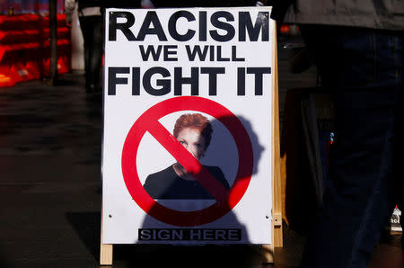 A protester casts his shadow across a poster displaying Australia's far-right politician Pauline Hanson during a rally orgnised to show support for the 'Black Lives Matter' movement, following recent police shootings in the U.S., in central Sydney, Australia, July 16, 2016. REUTERS/David Gray/File Photo