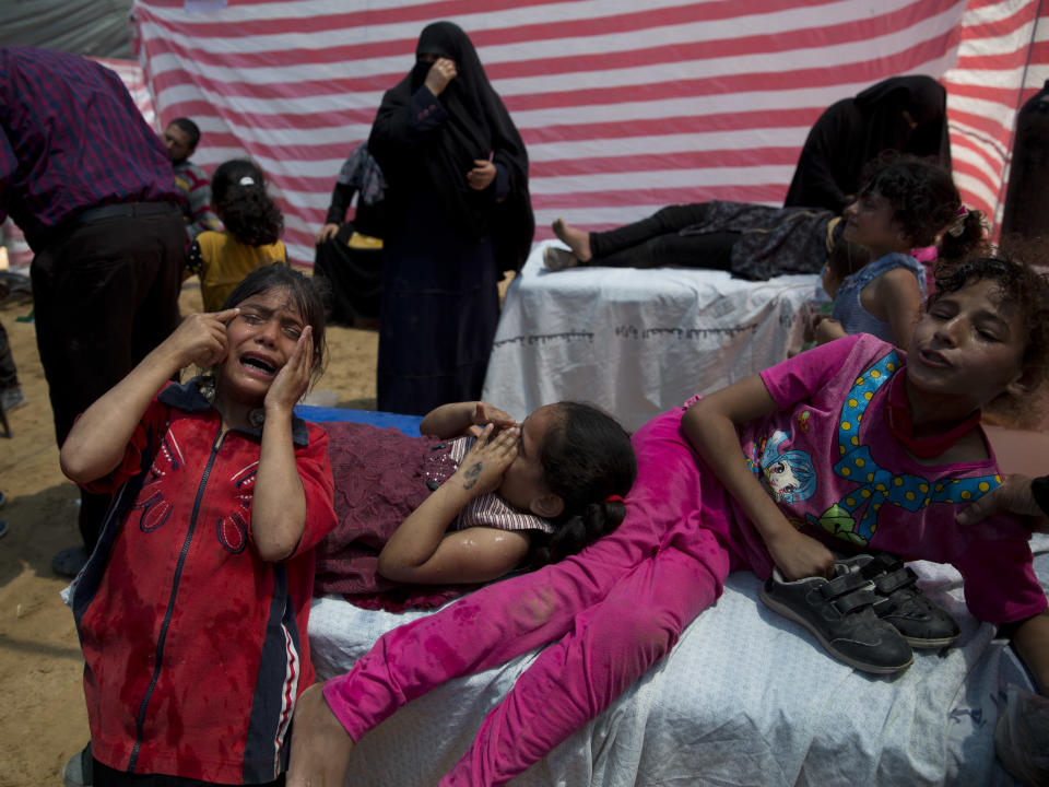 Palestinian children suffering from teargas inhalation recover in a medical tent during a protest near Beit Lahiya, Gaza Strip, Monday, May 14, 2018. (AP Photo/Dusan Vranic)