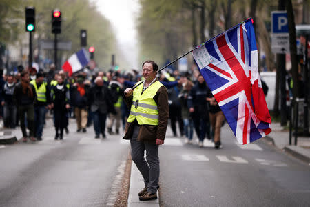 A protester waves a Union flag at Barbes station during the Act XIX (the 19th consecutive national protest on Saturday) of the "yellow vests" movement in Paris, France, March 23, 2019. REUTERS/Benoit Tessier