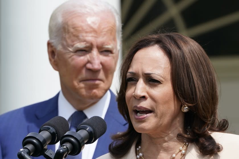 President Joe Biden, left, listens as Vice President Kamala Harris, right, speaks during an event in the Rose Garden of the White House in Washington, Monday, July 26, 2021, to highlight the bipartisan roots of the Americans with Disabilities Act and marking the law's 31st anniversary. (AP Photo/Susan Walsh)