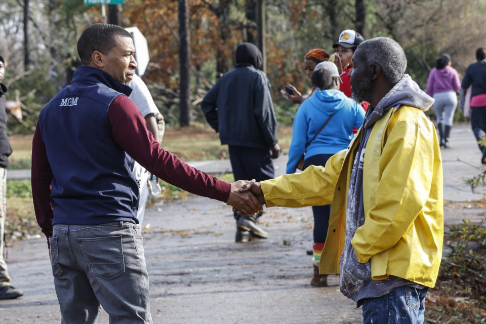 Montgomery, Ala., Mayor Steven Reed, left, speaks hands with Jefferey Jordan, right, Wednesday, Nov. 30, 2022, in Flatwood, Ala., who had damage to his home from a severe storm. Two people were killed in the Flatwood community just north of the city of Montgomery. (AP Photo/Butch Dill)