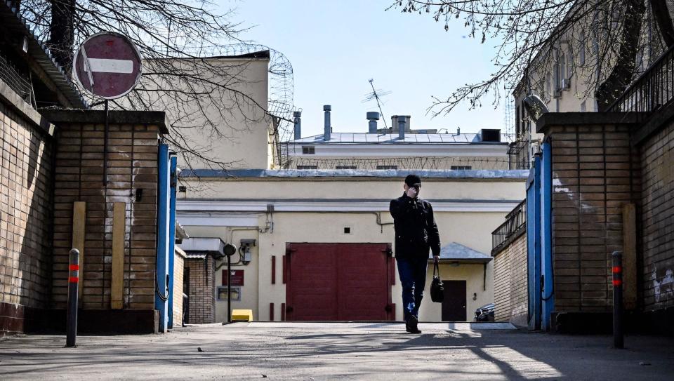 A man walks in front of the gated entrance to the Lefortovo prison, where Evan Gershkovich, US journalist arrested on espionage charges, is held in Moscow on April 12, 2023.