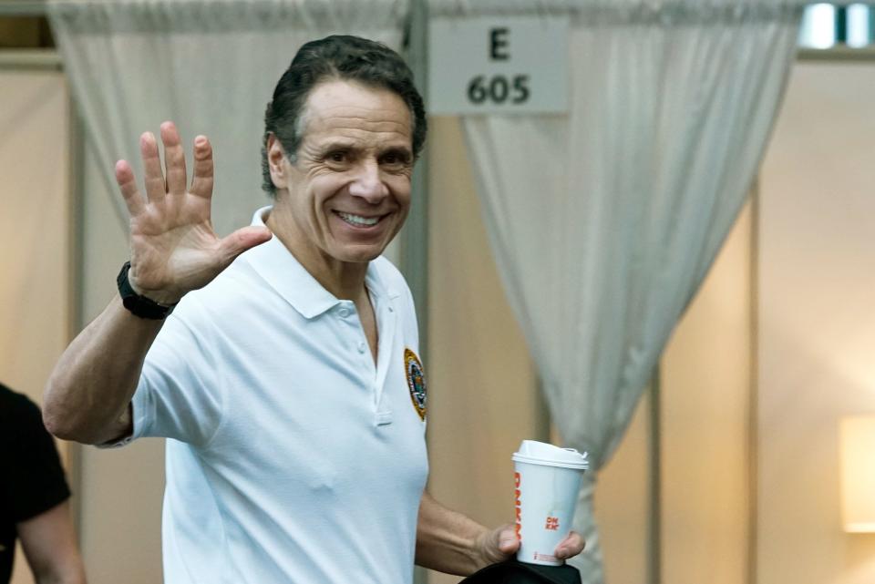 New York Gov. Andrew Cuomo (D) waves on Friday after he gave what has become daily briefings on the state's battle against the coronavirus pandemic. His Friday briefing took place at the Jacob K. Javits Convention Center, which is being turned into a hospital. (Eduardo Munoz Alvarez via Getty Images)