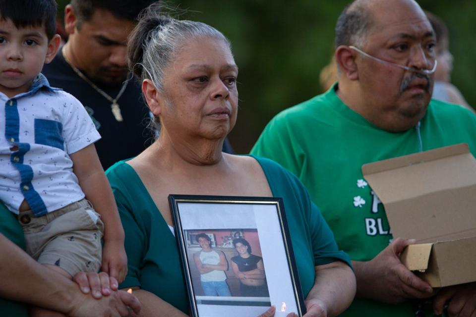 Myra Lopez holds a picture of a young Daniel Piedras Garcia at his vigil at Memorial Park on June 23, 2023. Garcia was fatally shot on US 54 while driving for Uber on June 16, 2023.
