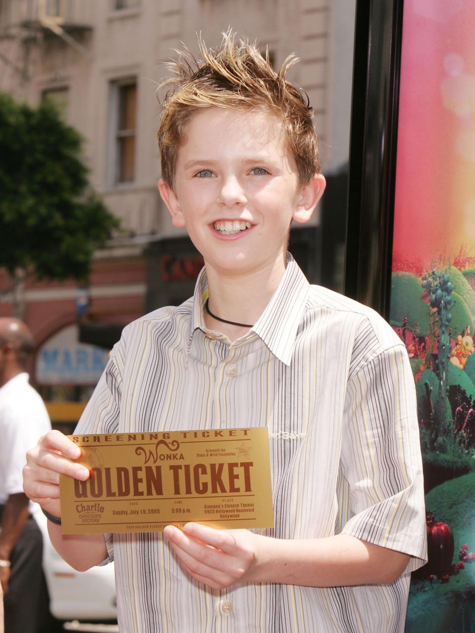 Freddie Highmore holding a golden ticket