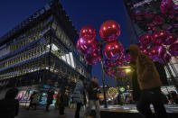 People walk through a Christmas decoration set up near an Adidas Store at an outdoor shopping mall in Beijing on Saturday, Dec. 23, 2023. It was tumultuous 2023 for the Chinese economy. Some of the world's biggest brands said they were weighing, or already have decided, to shift manufacturing away from China amid unease about security controls, government protection of their Chinese rivals and Beijing's wobbly relations with Washington. But there was at least one bright spot for Beijing amid all the tough news about declining foreign investment: American fast food companies have announced a surge of investment in a market of 1.4 billion people. KFC, McDonald's and Starbucks are among companies in recent months that have announced plans for major investment in China. (AP Photo/Andy Wong)