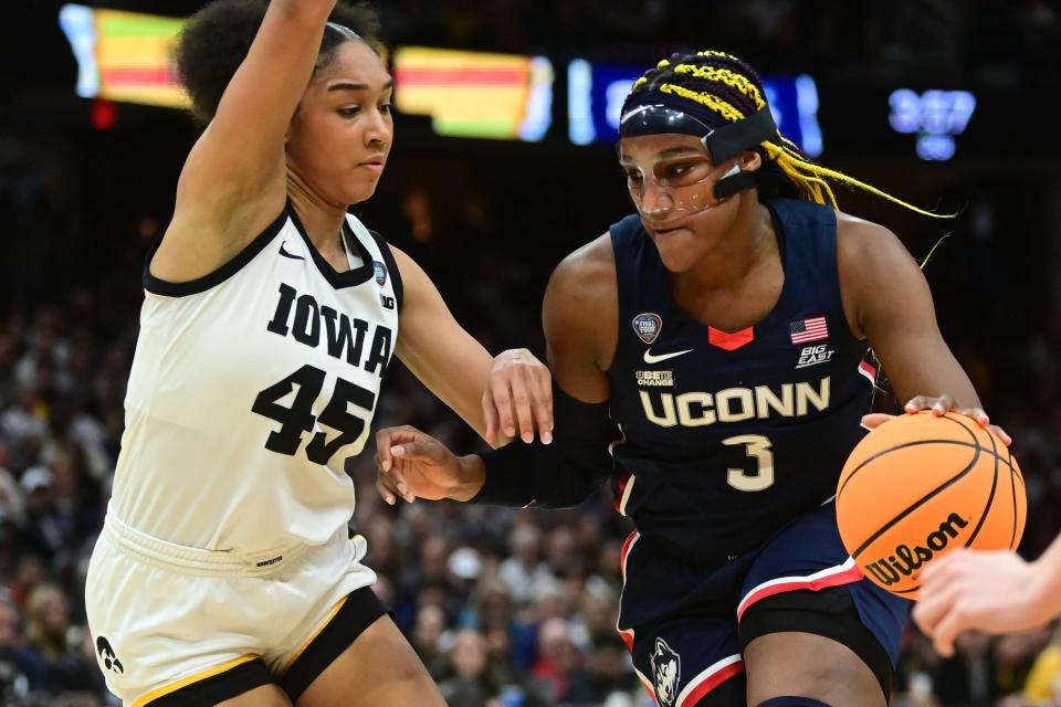 Connecticut's Aaliyah Edwards (3) dribbles the ball against Iowa's Hannah Stuelke (45) in the semifinals of the women's 2024 NCAA Tournament on Friday in Cleveland.