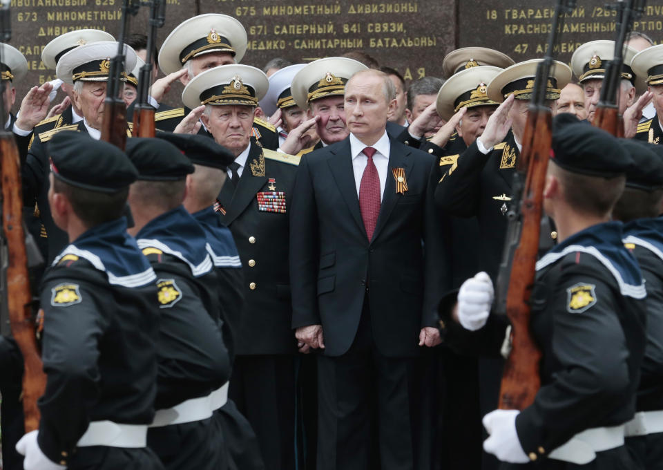 FILE In this file photo taken on Friday, May 9, 2014, Russian President Vladimir Putin attends a parade marking the Victory Day in Sevastopol, Crimea. The European Court of Human Rights decided Thursday Jan. 14, 2021, to start considering Ukraine's complaint against alleged human rights violations in the Russia-annexed Crimea. (AP Photo / Ivan Sekretarev, File)