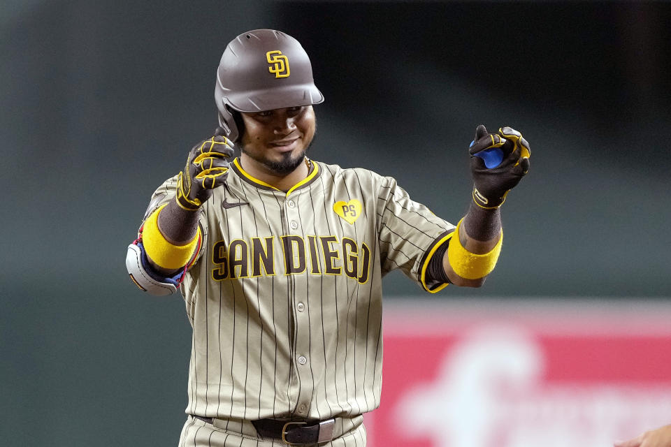 Luis Arráez celebrates his first hit with the Padres. (AP Photo/Matt York)