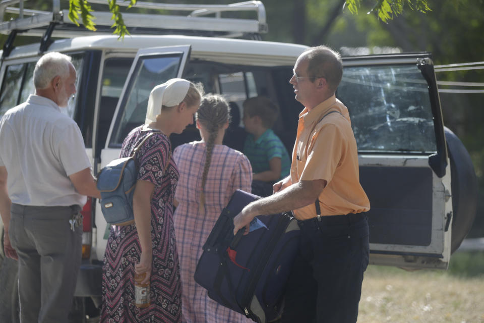 Unidentified people board a vehicle departing to the airport from the Christian Aid Ministries headquarters at Titanyen, north of Port-au-Prince, Haiti, Dec. 16, 2021. Twelve remaining members of a U.S.-based missionary group who were kidnapped two months ago have been freed, according to the group and to Haitian police. (AP Photo/Odelyn Joseph)