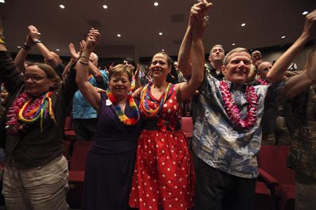 Deborah Cohn (L-R), Carolyn Golujuch, Michele Golujuch and Danny Robinson celebrate after Hawaii Governor Neil Abercrombie signed Senate Bill 1, allowing same sex marriage to be legal in the state, in Honolulu, Hawaii November 13, 2013. REUTERS/Hugh Gentry