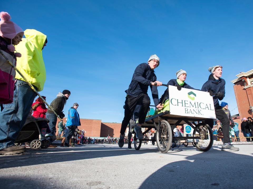 Members of the Yale Cross Country team pull Chemical Bank's sled down Superior Mall Saturday, Jan. 26, 2019 during the annual Port Huron Chilly Fest bed races.