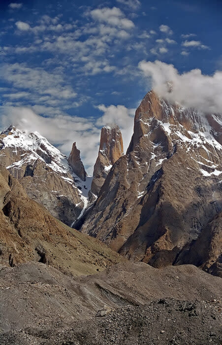 The Trango Towers partially capped by clouds