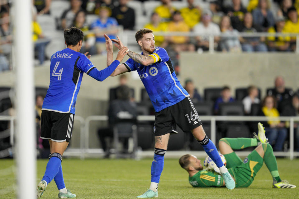 CF Montréal's Fernando Álvarez (4) celebrates with Joel Waterman (16) after a save by Jonathan Sirois against the Columbus Crew during the second half of an MLS soccer match Saturday, April 27, 2024, in Columbus, Ohio. (AP Photo/Jeff Dean)