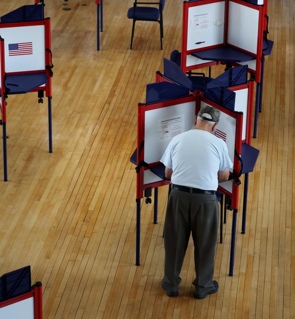 A voter fills out his ballot at an early voting location in Massachusetts. <a href="https://www.gettyimages.com/detail/news-photo/voter-fills-out-his-ballot-at-the-early-voting-location-at-news-photo/1242803355?adppopup=true" rel="nofollow noopener" target="_blank" data-ylk="slk:Craig F. Walker/The Boston Globe via Getty Images;elm:context_link;itc:0;sec:content-canvas" class="link ">Craig F. Walker/The Boston Globe via Getty Images</a>