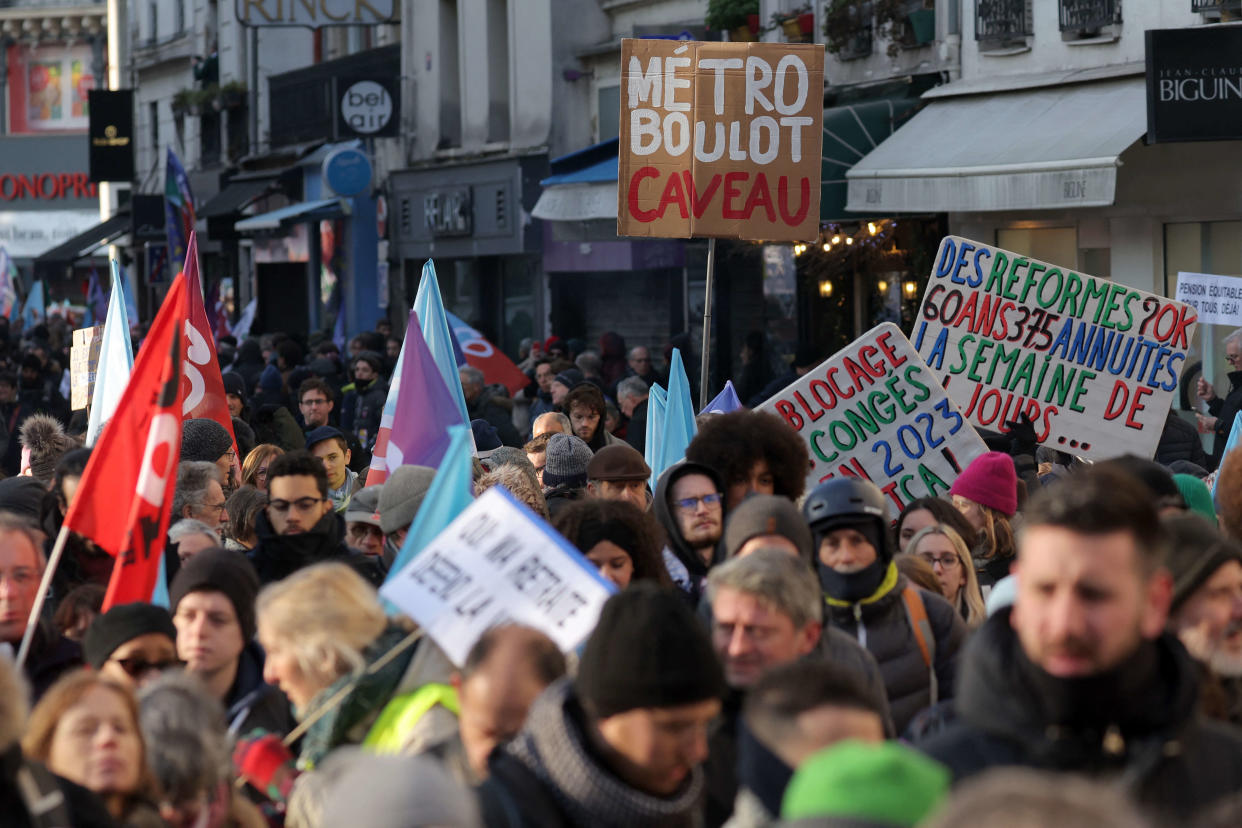 Demonstrators, including one holding a placard (C) reading 