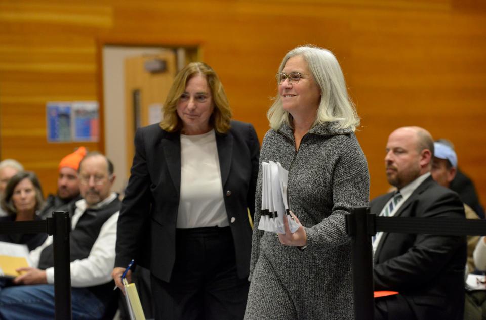 Susan Rocca, right, and her attorney Donna Brewer walk to a table in front of the Truro Board of Registrars on Monday at the Truro Community Center. Rocca's was the first hearing before the board, and the board voted to allow her to remain as a Truro voter.