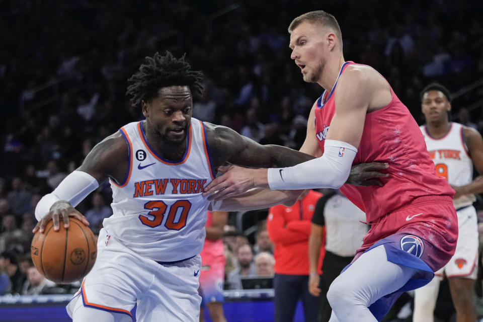 New York Knicks forward Julius Randle (30) drives against Washington Wizards center Kristaps Porzingis during the first half of an NBA basketball game Wednesday, Jan. 18, 2023, at Madison Square Garden in New York. (AP Photo/Mary Altaffer)