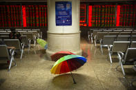 Umbrellas sit in a stock brokerage house in Beijing, Tuesday, Aug. 20, 2019. Asian shares were mostly higher Tuesday after Wall Street rallied on the U.S. decision to give Chinese telecom giant Huawei another 90 days to buy equipment from American suppliers. (AP Photo/Mark Schiefelbein)