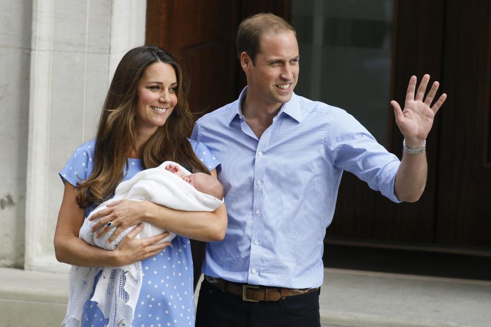 Britain's Prince William, right, and Kate, Duchess of Cambridge, hold the Prince of Cambridge, Tuesday July 23, 2013, as they pose for photographers outside St. Mary's Hospital exclusive Lindo Wing in London where the Duchess gave birth on Monday July 22. The Royal couple are expected to head to London’s Kensington Palace from the hospital with their newly born son, the third in line to the British throne. (AP Photo/Kirsty Wigglesworth)