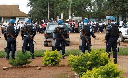 FILE PHOTO: Peacekeepers serving in the United Nations Organization Stabilization Mission in the Democratic Republic of the Congo (MONUSCO) stand guard in a formation following recent demonstrations in Beni in North Kivu province, Congo on October 23, 2014. REUTERS/Kenny Katombe/File Photo