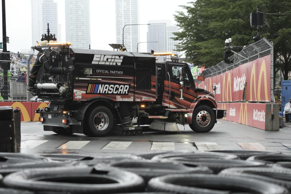 Crews dry the track before a NASCAR Cup Series auto race at the Grant Park 220 Sunday, July 2, 2023, in Chicago. (AP Photo/Morry Gash)