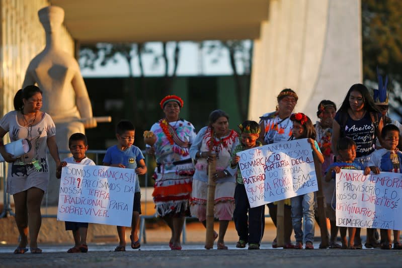 FILE PHOTO: Indigenous people from the Guarani Kaiowa tribe attend a protest to defend indigenous land, outside Brazil's Supreme Federal Court in Brasilia