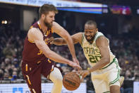Boston Celtics' Jabari Parker (20) drives past Cleveland Cavaliers' Dean Wade (32) in the first half of an NBA basketball game, Saturday, Nov. 13, 2021, in Cleveland. (AP Photo/Tony Dejak)