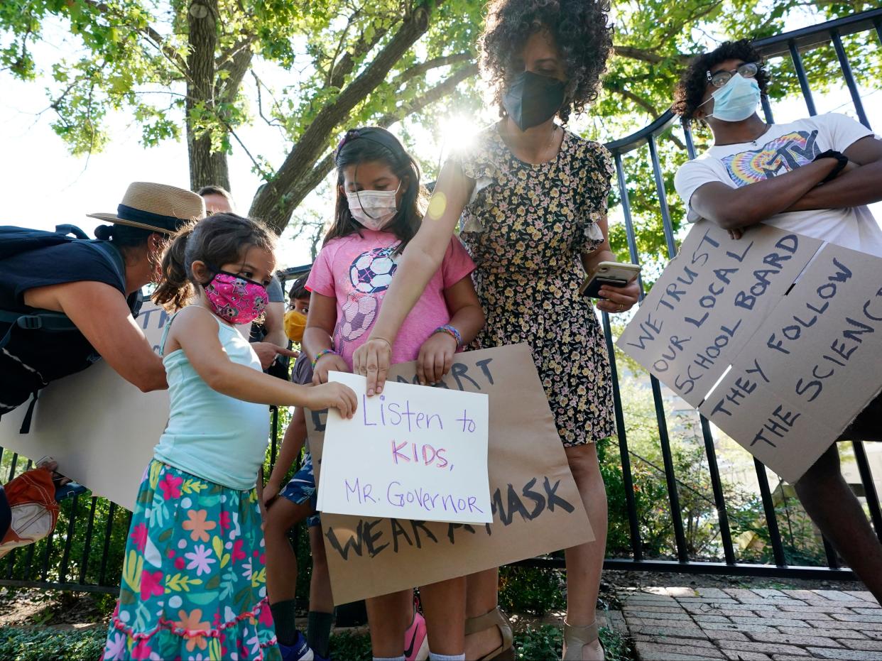 Parents and school children protest outside the Texas governor’s mansion (AP)